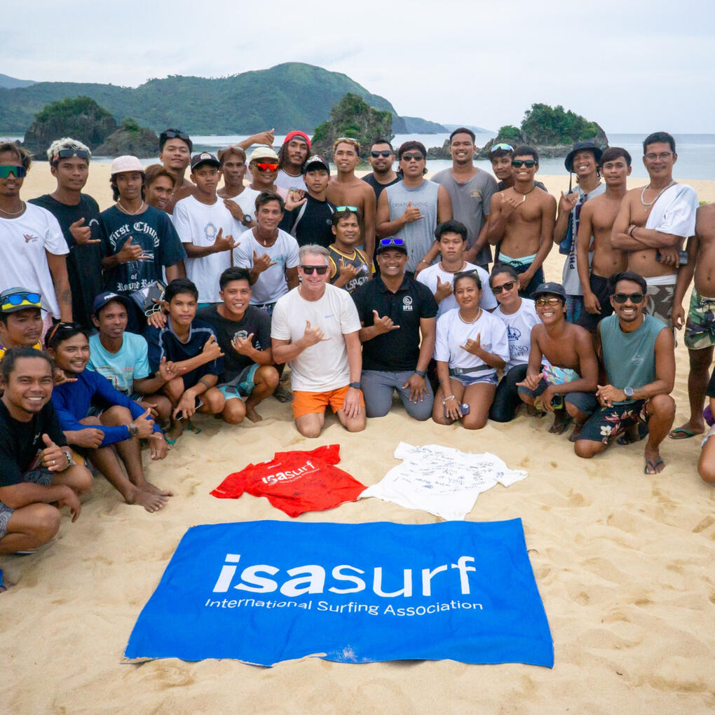 Government officials and local surf club representatives of Guiuan perform the ceremonial breaking of the board.